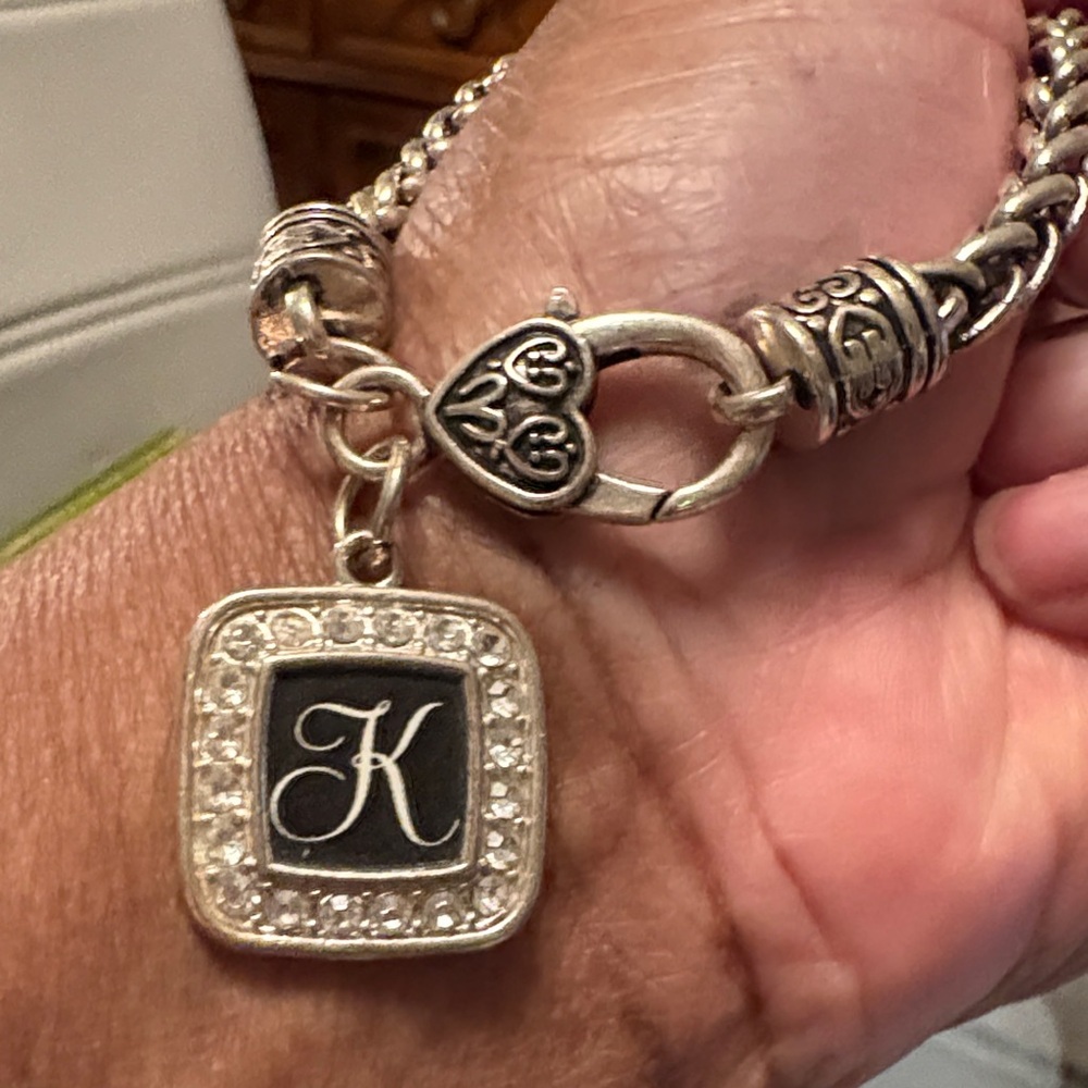 Elegant Silvertone Bracelet with Black Charm K, inscribed